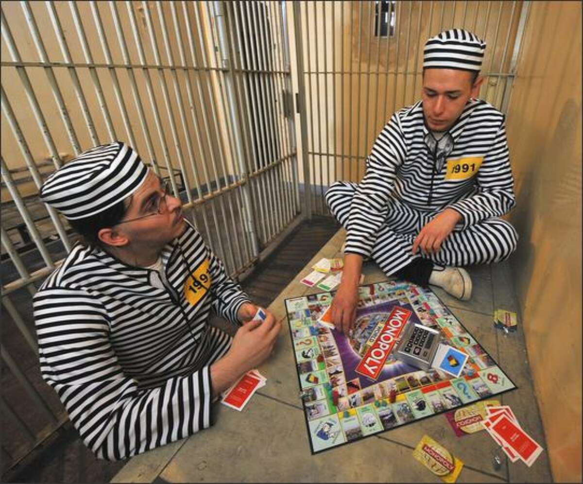 Marcel Pozgay, left, and Christian Michael sit in a cell of the former "Klapperfeldstrasse Custody" and play Monopoly on Wednesday in Frankfurt, western Germany, as they take part in a world record attempt. Players in 22 cities - among them London, Las Vegas, Toronto and Kiev - took part in a world-wide bid to set a new Guinness World Record for most people playing the board game "Monopoly" simultaneously.