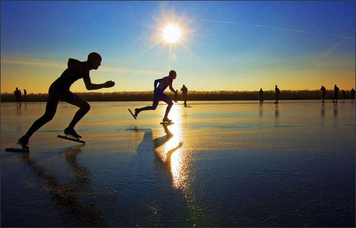 Skaters compete on a track of ice created from grassland sprayed with water, in the northern Dutch province of Frieslands on Monday.