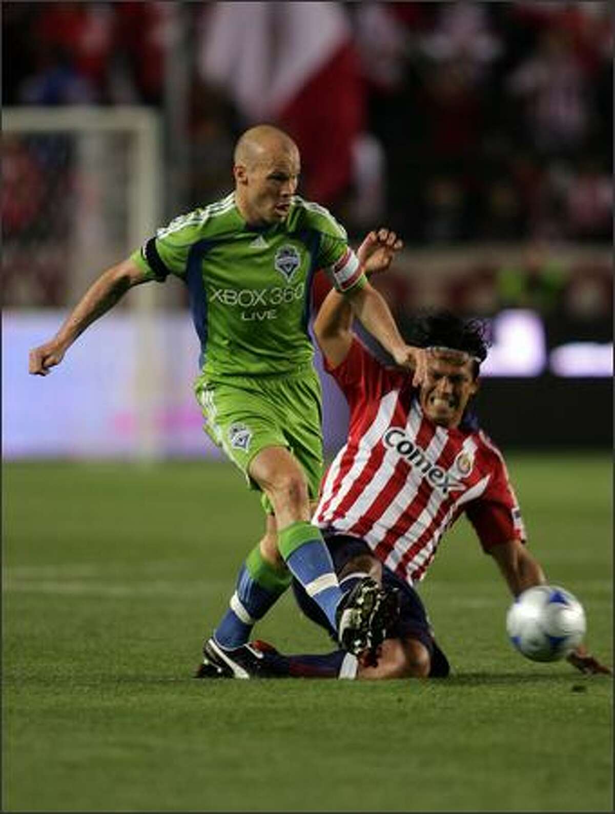Freddie Ljungberg of Seattle Sounders FC gets off a pass as Eduardo Lillingston of Chivas USA slides in for the tackle in the first half during an MLS match at The Home Depot Center in Carson, Calif., on Saturday, April 18, 2009.