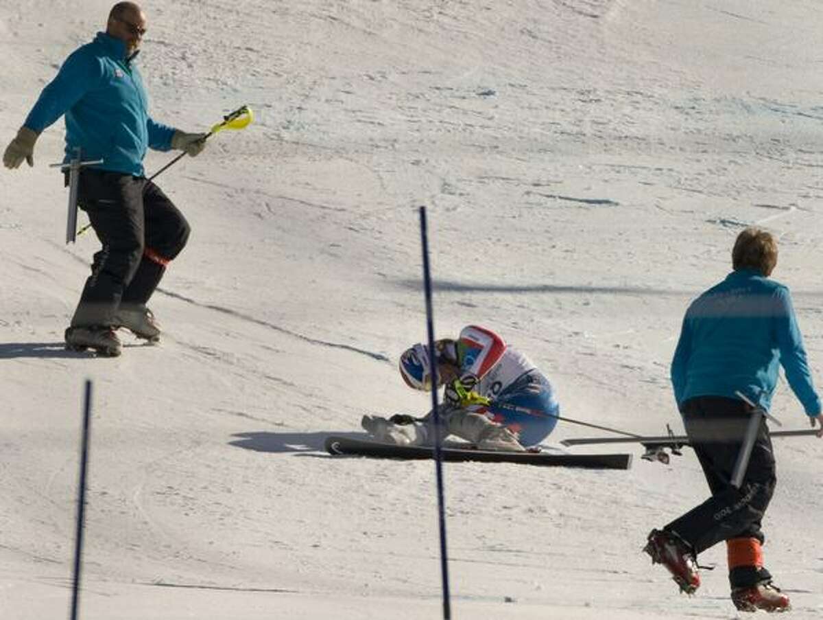 Course workers retrieve a pole and a ski after Lindsey Vonn crashes within sight of the finish line during the slalom portion of the womens super combined event at Whistler Creekside at the 2010 Winter Olympic Games on Thursday, Feb. 18, 2010, in Vancouver. ( Jay Hu / For the Houston Chronicle ).