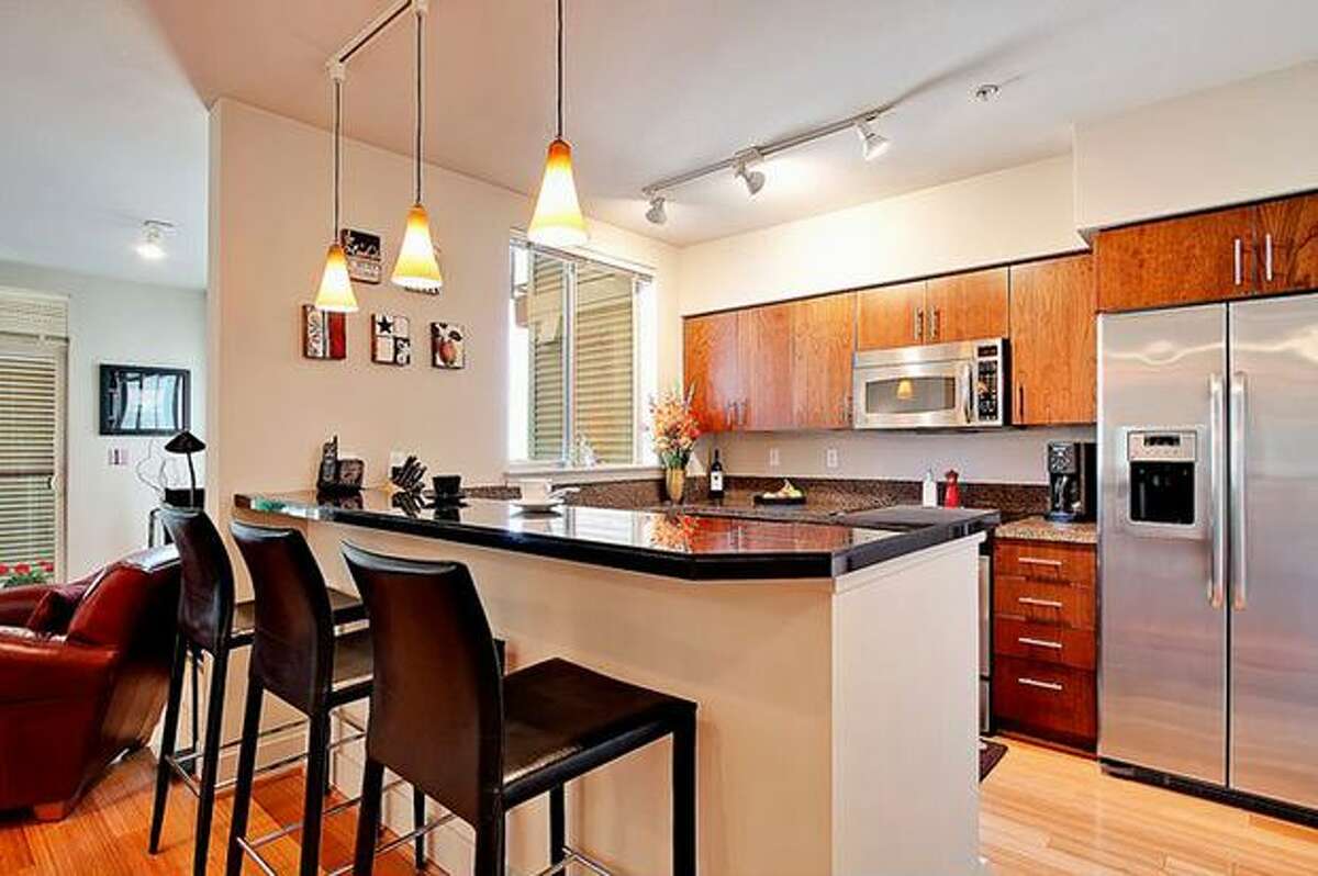 The kitchen has stainless steel appliances and slab granite counters. (Windermere.com) See the listing