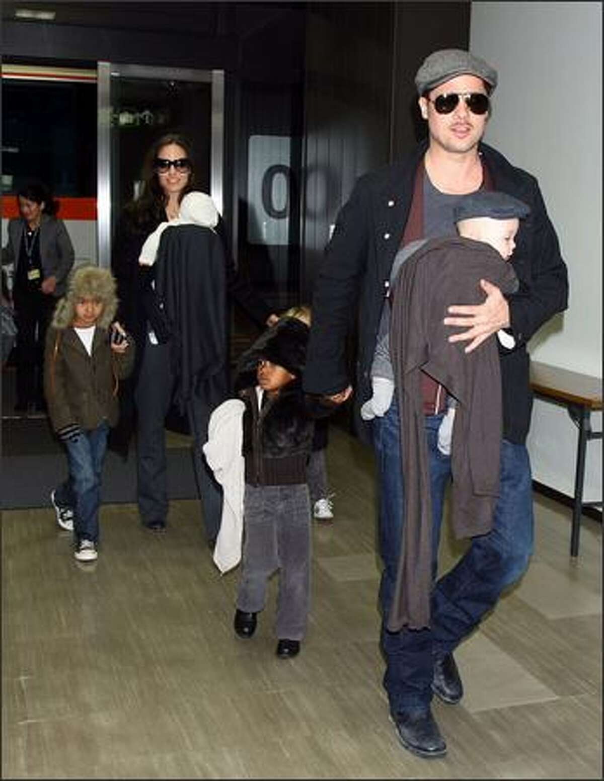 Actor Brad Pitt and Angelina Jolie arrive at Narita International Airport with their children (L to R) Maddox, Vivienne, Zahara and Knox in Narita, Chiba, Japan. Brad is visiting Japan to promote his film "The Curious Case Of Benjamin Button".