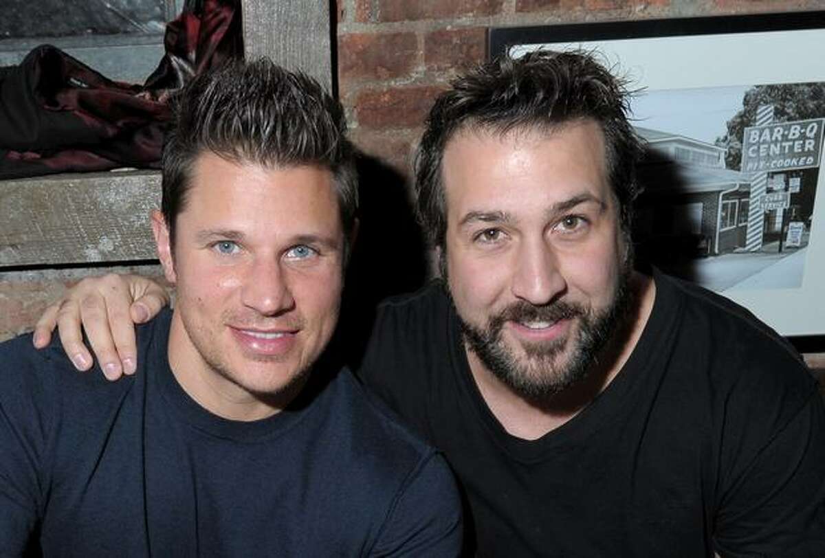 Singers (L-R) Nick Lachey and Joey Fatone attend the Brother Jimmy's Union Square grand opening at Brother Jimmy's in New York City.