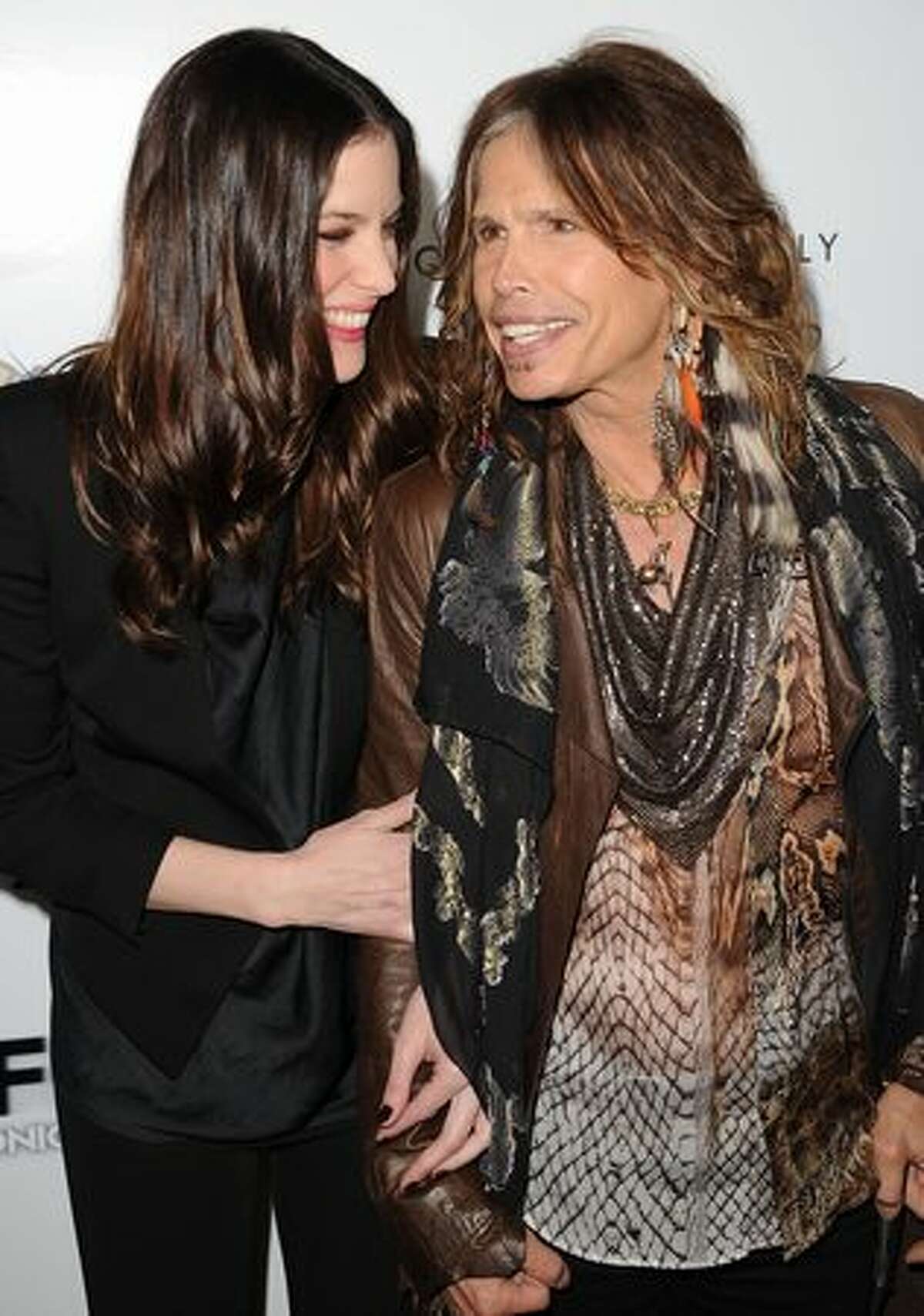 Actress Liv Tyler and singer Steven Tyler arrive at the premiere of IFC Midnight's 'Super' at the Egyptian Theatre in Hollywood, California.
