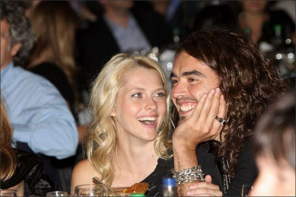 Actor Russell Brand and Teresa Palmer attend The O2 Silver Clef Awards Luncheon in aid of Nordoff-Robbins Music Therapy at The Hilton Park Lane in London, England.