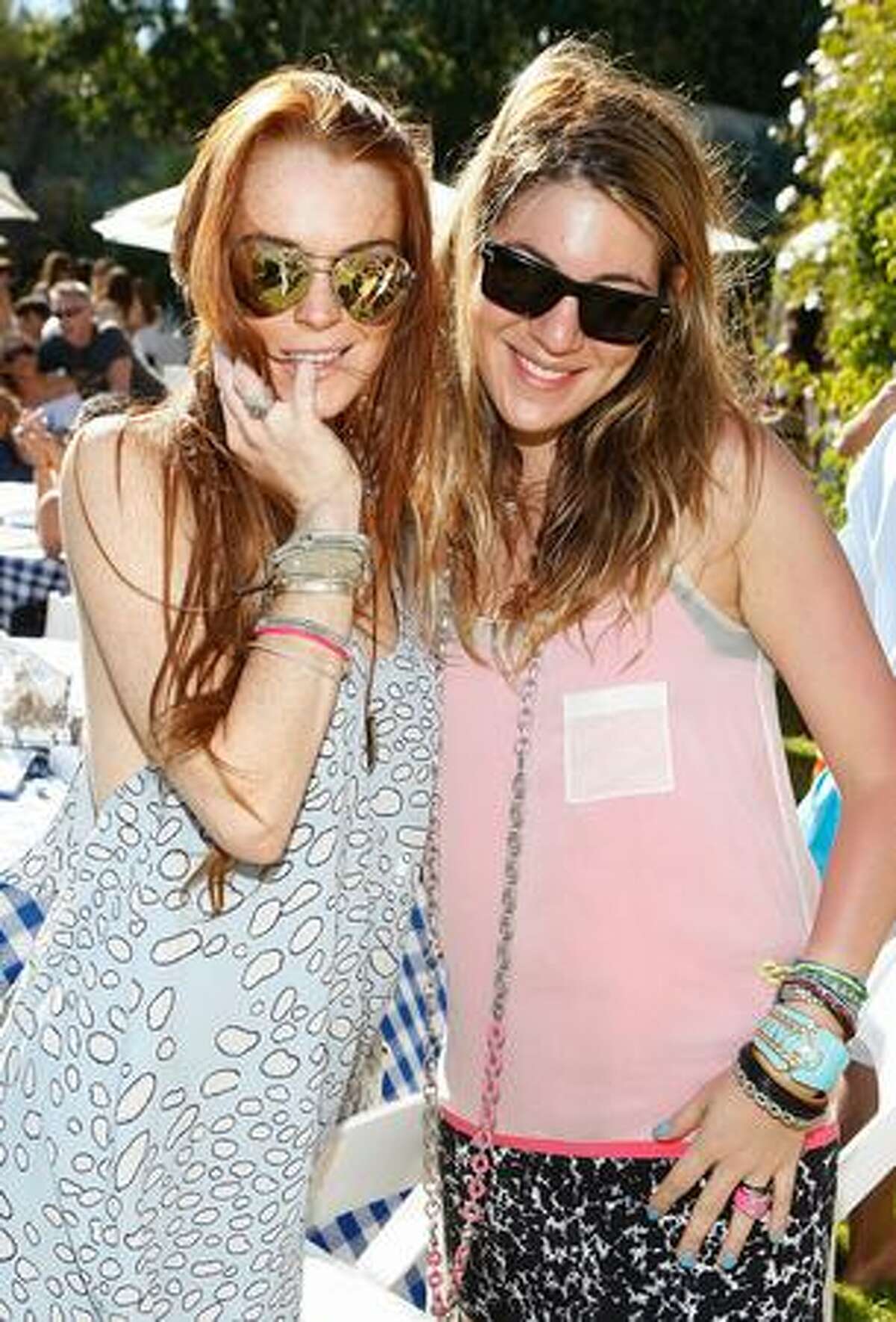 Actress Lindsay Lohan (L) and designer Dani Stahl attend the Lia Sophia Clam Bake at a private residence in Malibu, California.