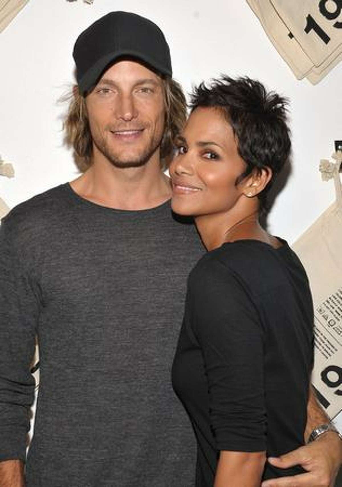 Actress Halle Berry (R) and Gabriel Aubry attend the launch event for Gap's 1969 Jean Shop on Robertson Blvd at their 1969 Jean Shop in West Hollywood, California.