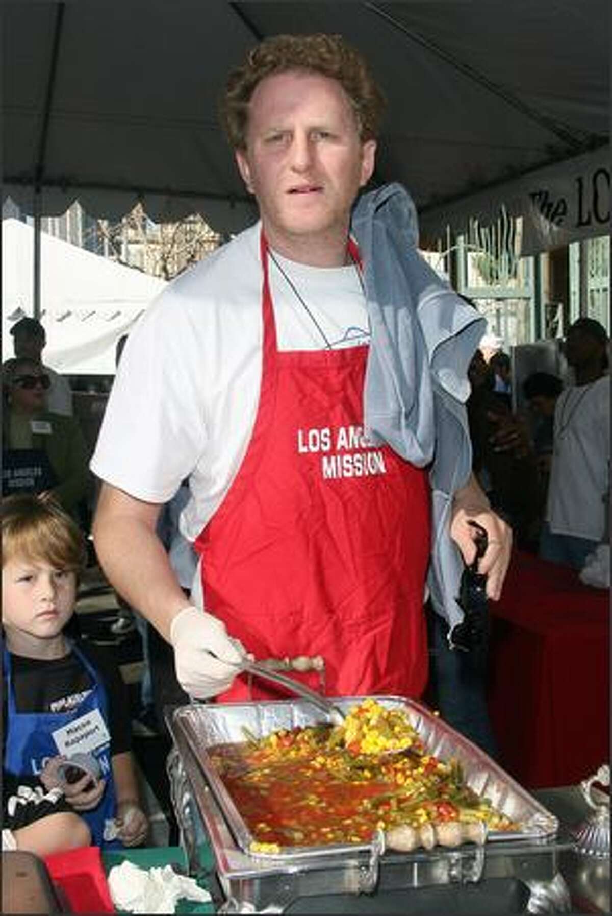 Actor Michael Rapaport and son serve Christmas meals to the homeless at the L.A. Mission in downtown Los Angeles, California.