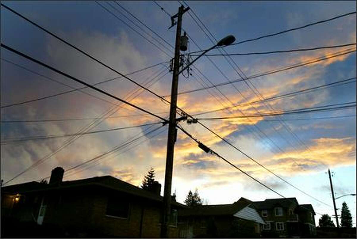 Dark clouds loom over a Ballard neighborhood and its power lines.