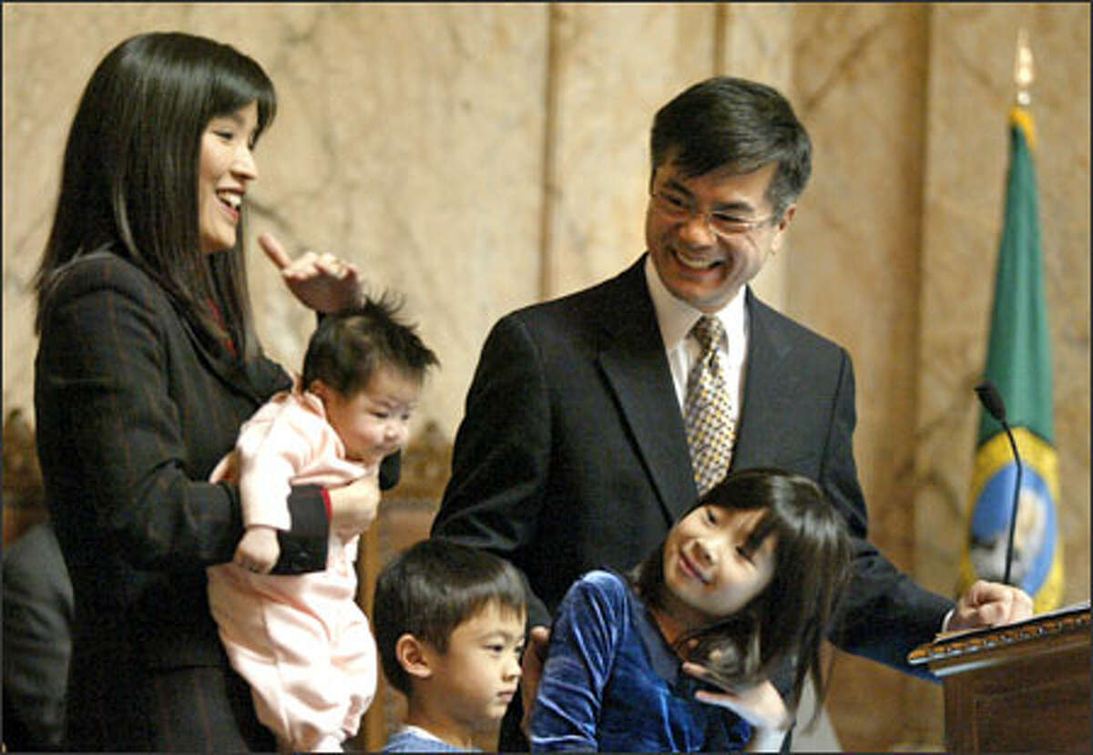 Gov. Gary Locke says goodbye at the state House in Olympia with his family: wife Mona Lee; new daughter Madeline; son Dylan; and other daughter Emily. Locke's term as governor ends Wednesday at noon.