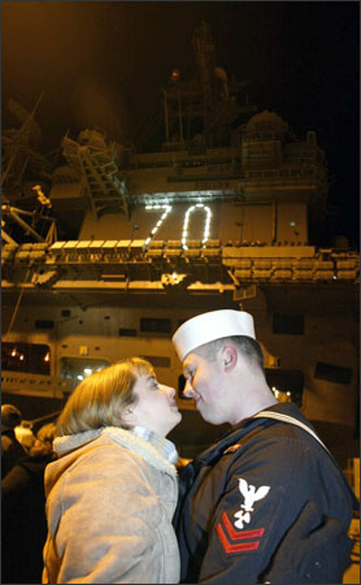 Susan Higbe gazes into the eyes of her husband of 15 months, Petty Officer 2nd Class Joe Higbe, before he boards the USS Carl Vinson. Higbe was among sailors who left Bremerton Thursday for a six-month, round-the-world cruise that will end in Norfolk, Va.