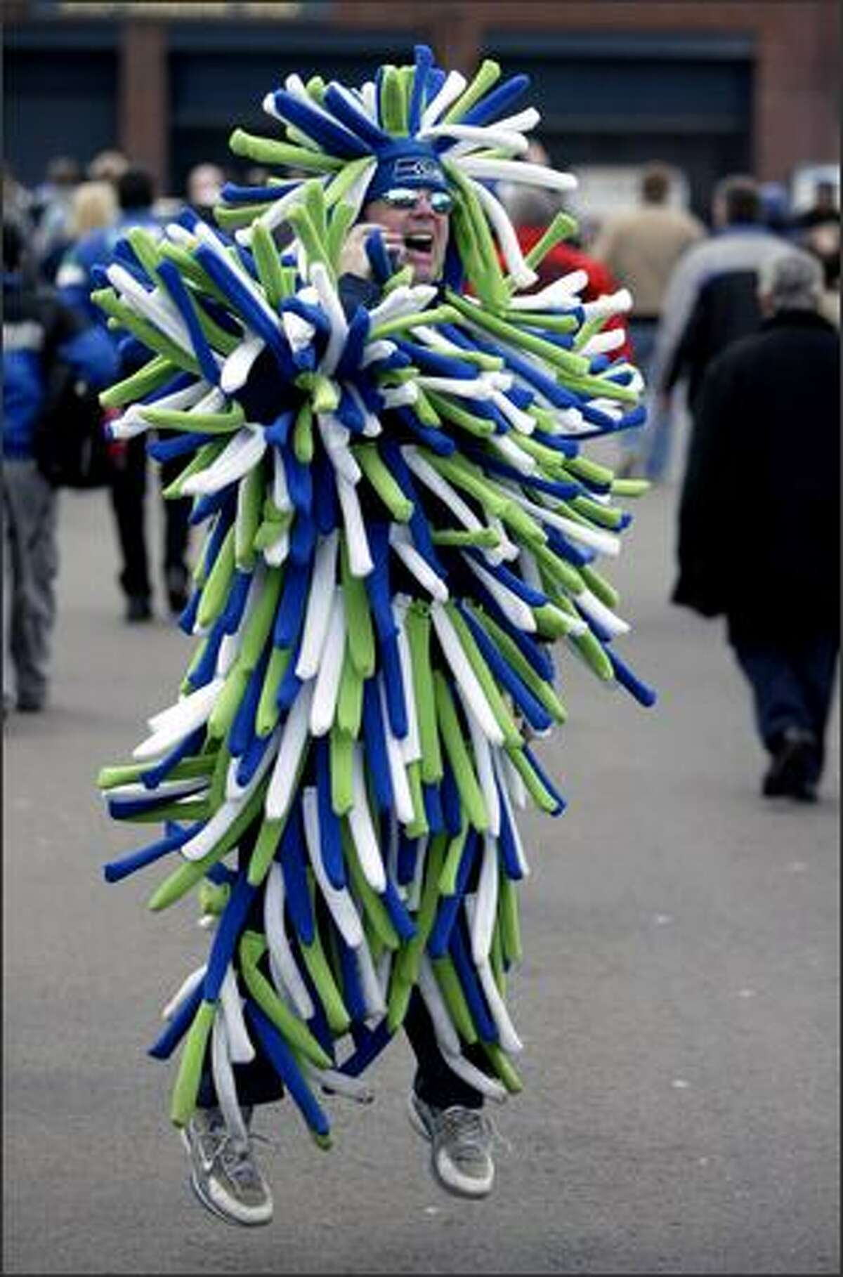 Seahawks fan Mark Williams of Puyallup jumps up in a handmade outfit as he tries to get a friend's attention prior to the NFC Championship Game between the Hawks and the Carolina Panthers. The Seahawks won 34-14 to advance to the Super Bowl against the Pittsburgh Steelers.