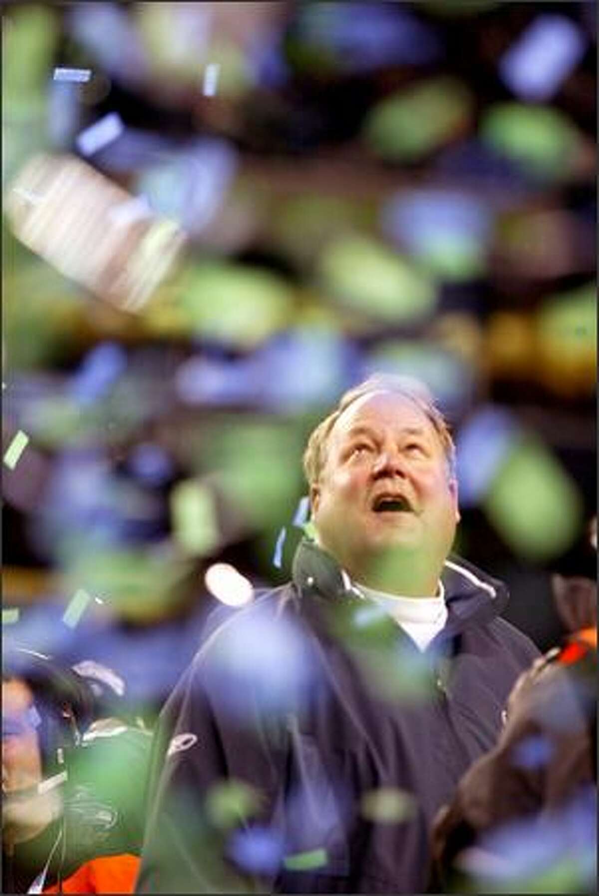 Coach Mike Holmgren watches as confetti falls during the trophy presentation ceremony after the Seahawks won the NFC Championship.