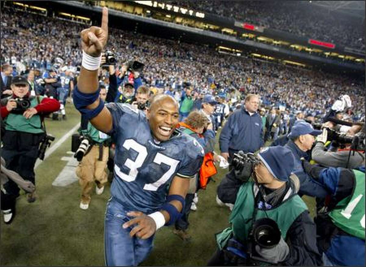 Running back Shaun Alexander runs onto the field to celebrate the Seahawks' NFC Championship victory after time expires.