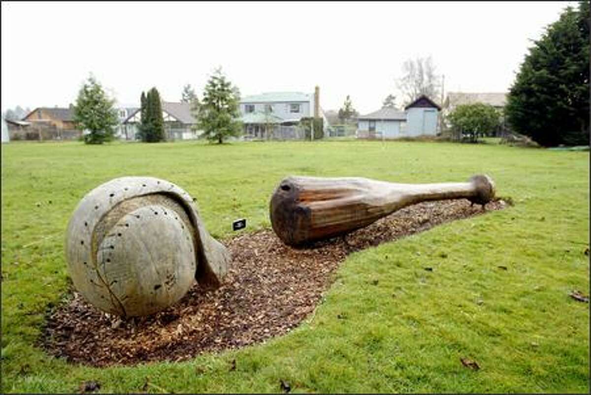 Wood sculptor Pat McVay's whimsical ball and bat are among the installations that make the Everett Arboretum seem like a gallery as much as gardens.