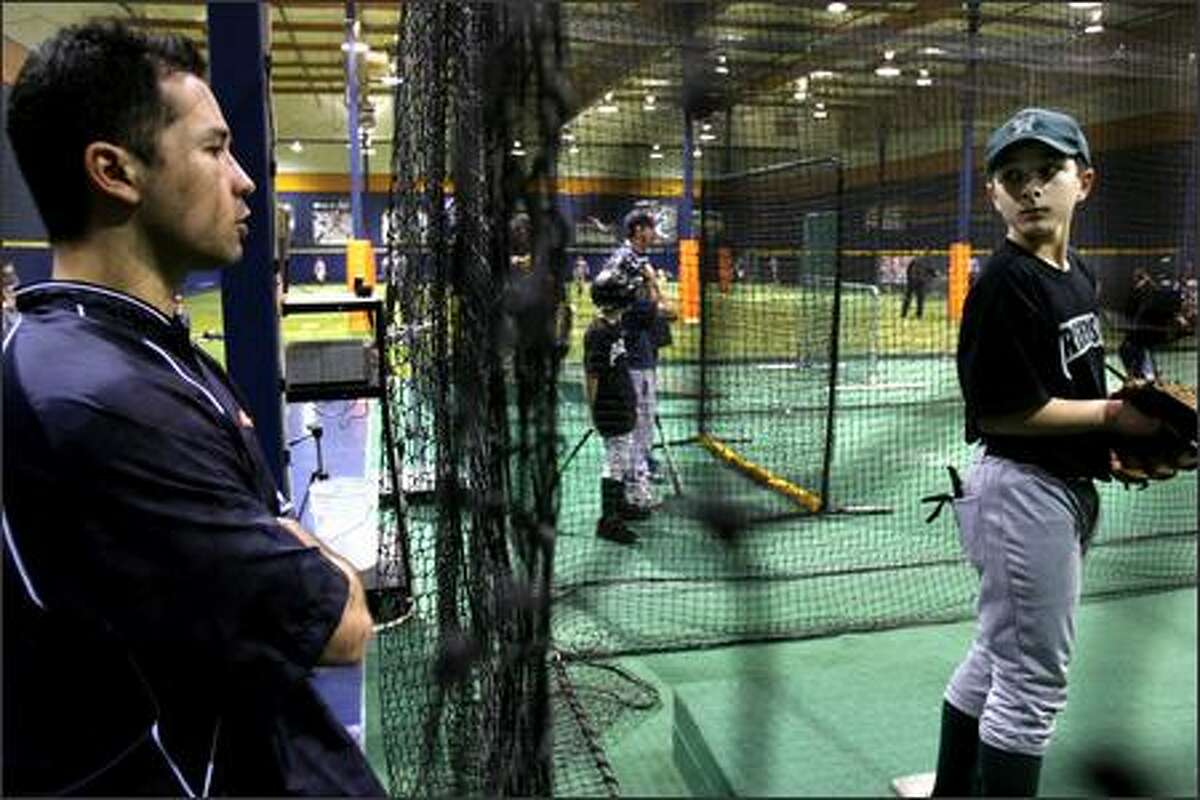 Pitcher Jim Parque gives some tips to Mitchell Ciotta, 11, of Federal Way, at his Big League Edge complex in Auburn. Parque will be attending the Seattle Mariners' 2007 training camp.