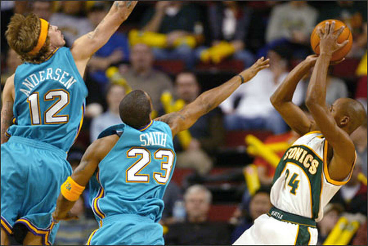 Ray Allen leans back to nail a shot against the Hornets' Chris Andersen and J.R. Smith. Allen scored a game-high 26 points on 11-of-17 shooting as the Sonics won their third consecutive game.