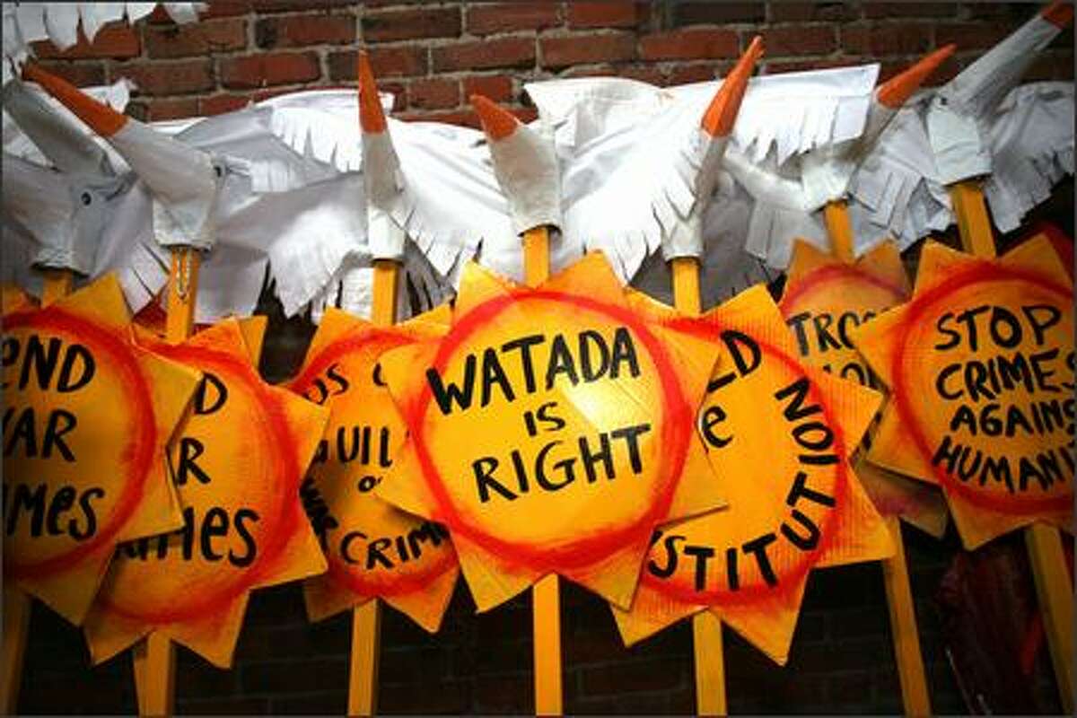 Paper "peace" birds adorn the top of protest signs designed to be used as props during a "street theater" demonstration, featuring giant puppets, planned for the beginning of Army 1st Lt. Ehren Watada's court-martial -- which ended abruptly in a mistrial.