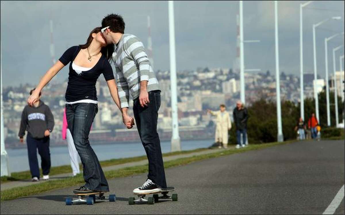 Angie Sherbina, 16, and her boyfriend Rod Lats,19, both from Federal Way, Wash., skateboard along Alki Beach on Harbor Ave. and Alki Ave. SW on Valentine's Day. "After this I'm going to surprise her with something," said Rod "and then take her out to dinner." The couple spent the "whole day hanging out together". "Being together on a sunny day is just great." said Rod.
