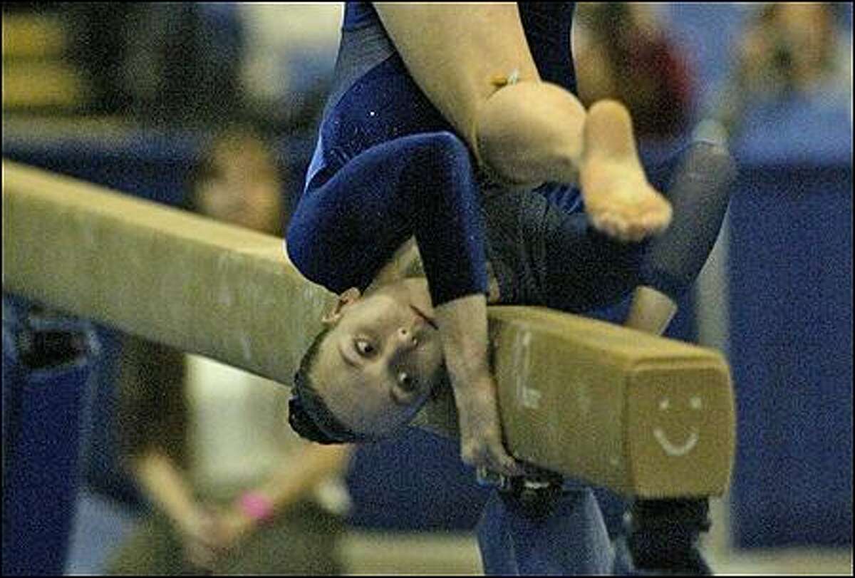 Liberty's Kara Bennett gets added support from a smiley face on the beam during the state championships.