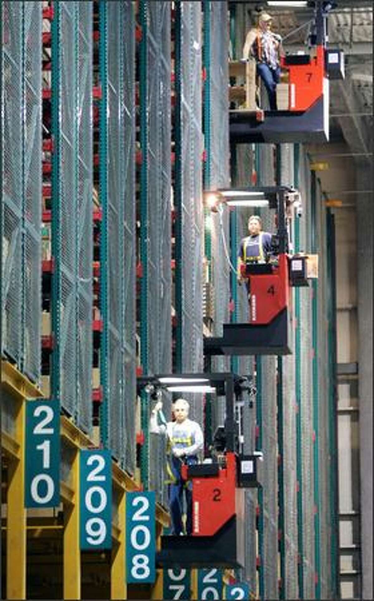 Boeing workers use these lifts to travel up to 60 feet to the top of huge storage bays at the Boeing Spares Distribution Center in SeaTac to fetch parts. The 24 high bay bins, each 60 feet high and 320 feet long, hold 5.9 million cubic feet of storage.