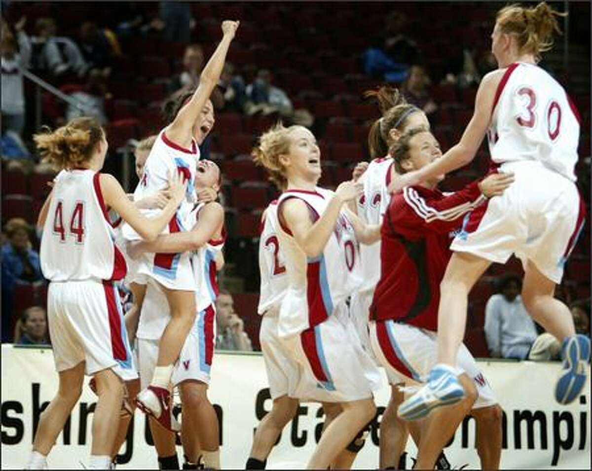 West Valley Rams players celebrate after defeating the White River Hornets in overtime at KeyArena.
