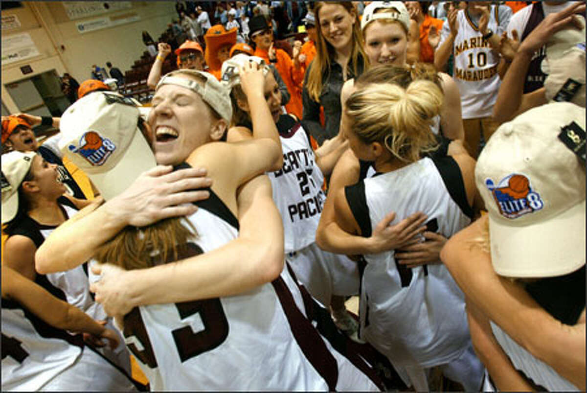 Seattle Pacific University's Carli Smith, facing, hugs Brittney Kroon after the Falcons raced to an 85-70 victory over Chico State to reach the Elite Eight.