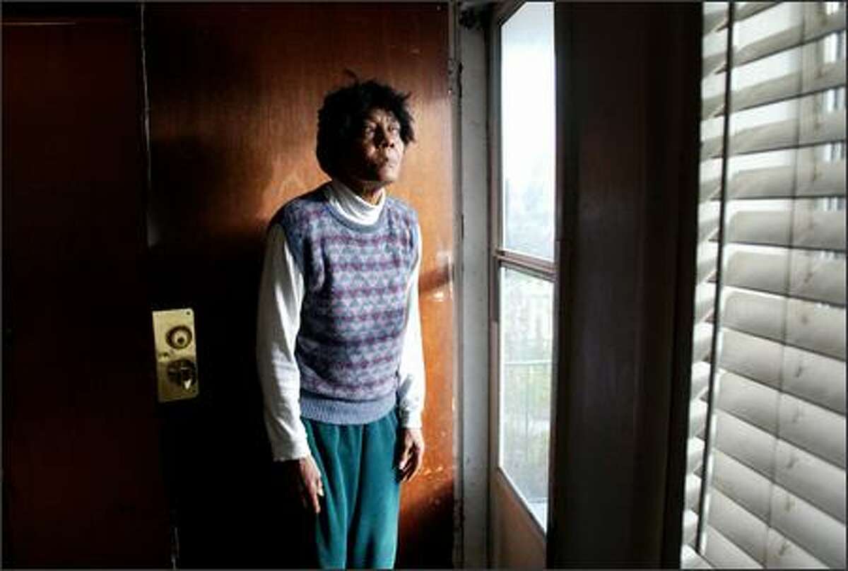 Devaney White photographed at the front door of her Central District home on Wednesday. Her bank has begun foreclosure action against her. (Paul Joseph Brown/Seattle P-I)