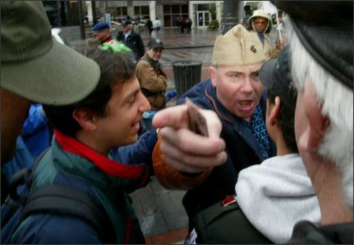 Earl Parker (from Chicago) argues with another vet during an anti-war rally called Troops Home Now at Westlake Center in Seattle on Monday. Parker said he fought as a marine in Vietnam and Desert Storm and supports the Iraq War.