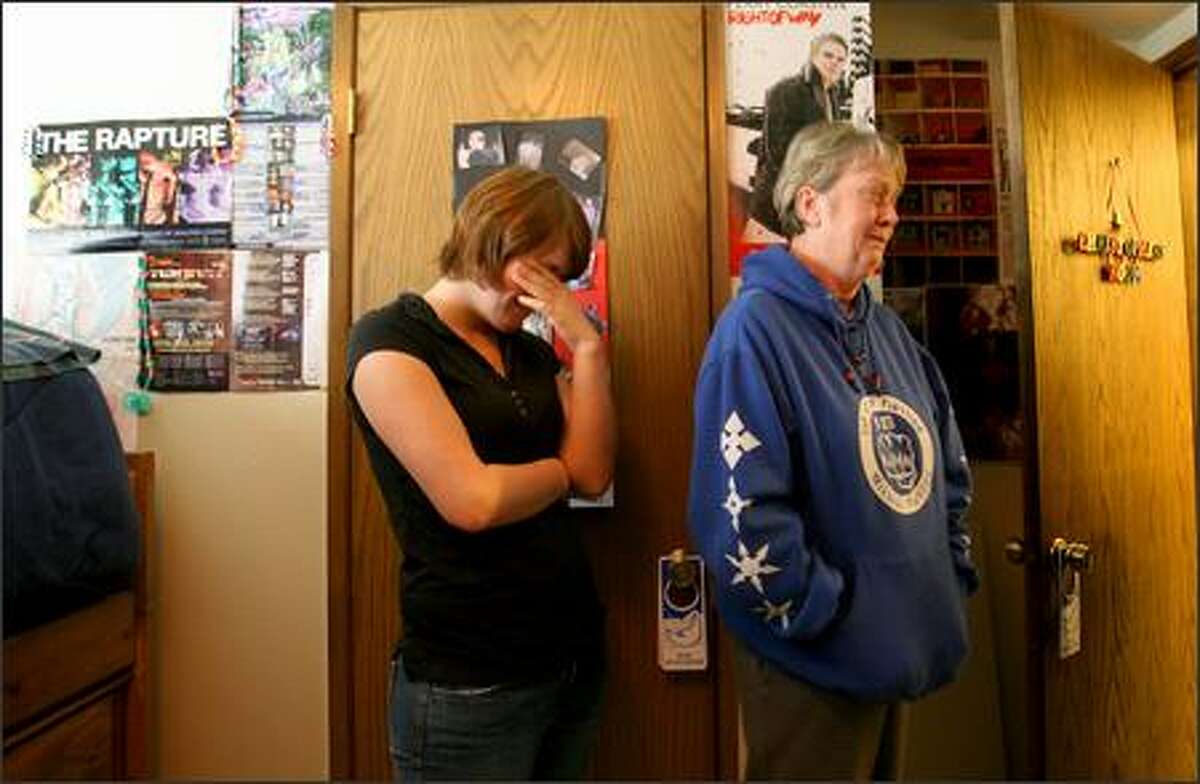It's been one year since six people were killed by a suicidal gunman in Capitol Hill. Sandie Williamson, right, mother of Christopher Williamson, one of the six who were killed, and Christopher's best friend Jessie become emotional as they looked around Christopher's room, which is the way he left it the day he was killed.