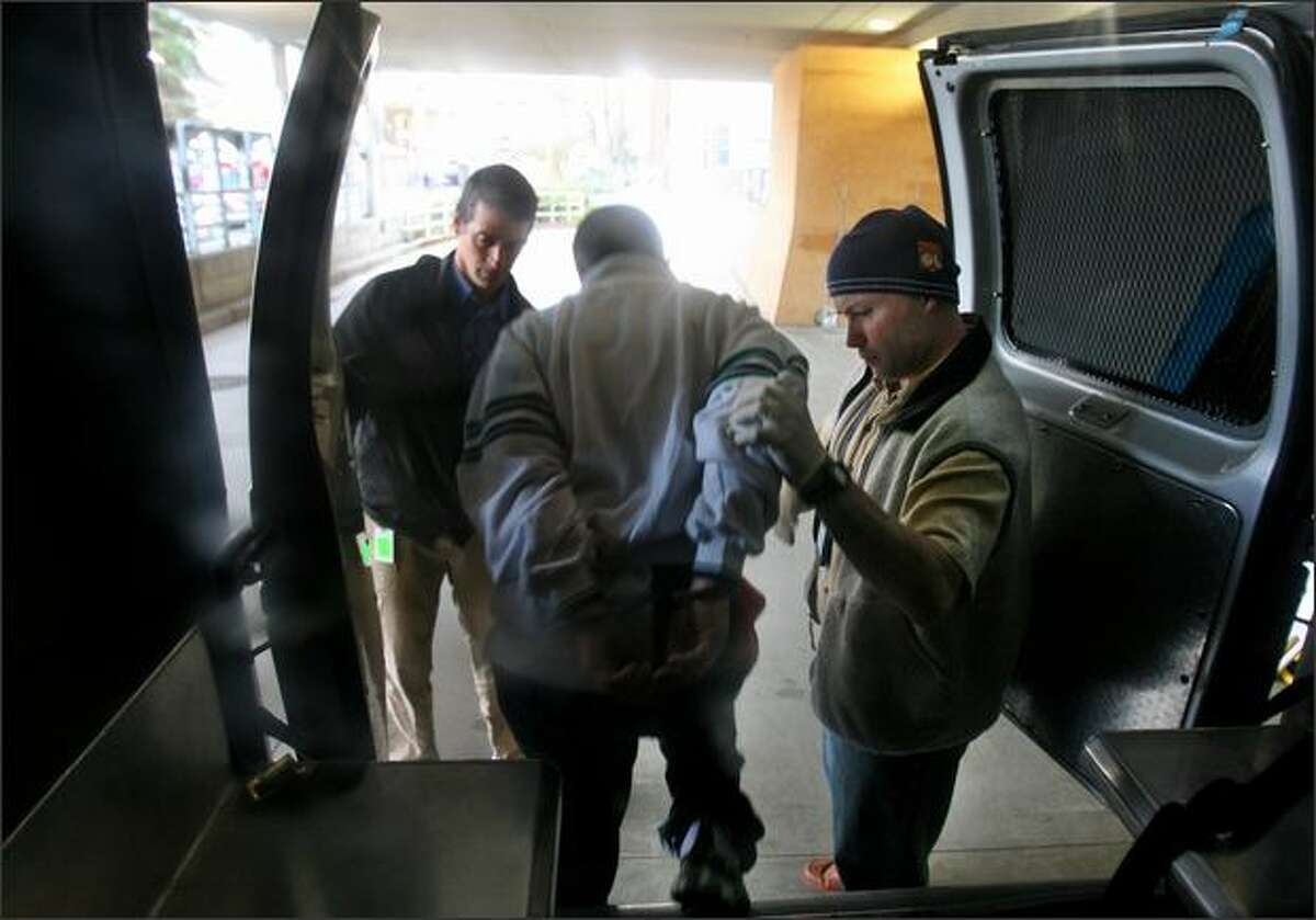 DOC community corrections officers Randy Vanzandt (left) and Thomas McJilton, deliver a mentally ill offender to Harborview Medical Center after she claimed she swallowed rocks of crack cocaine in Seattle. The offender was arrested for not checking in with her supervisors as required.