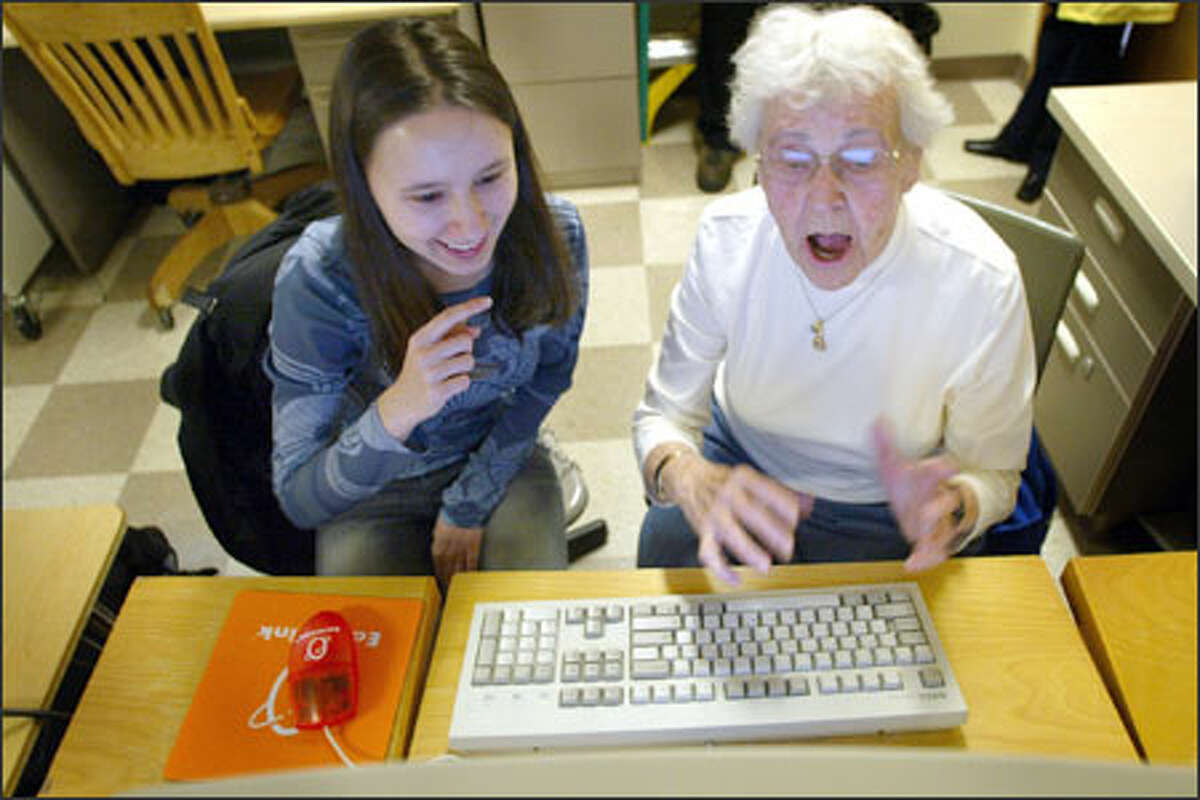 Katherine Herndon, 89, sends her first e-mail with the help of her young instructor, Ana-Maria Standolariu, 17, during a computer class at Ballard High School.