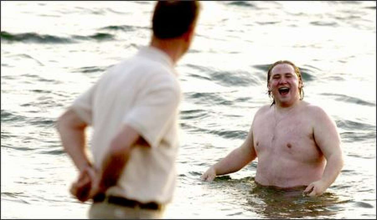 Sven Westergard takes an impromptu swim in the chilly waters of Puget Sound at Golden Gardens Park. A record-high temperature of 78 degrees yesterday had people all over the region soaking up summerlike conditions. Westergard, who is visiting Seattle from Ketchikan, Alaska, said the last time he swam at home, he "had to break the ice first." As he ran for the Sound yesterday, friends on the beach yelled, "Free Willy!" Things are expected to return to normal and cool off today, with a high temperature forecast in the 50s.
