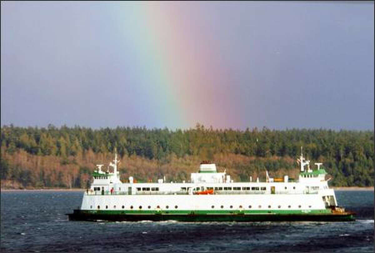 Passengers on the Glacier Spirit get a colorful postcard-perfect view of a rainbow as they cruise through Admiralty Inlet.
