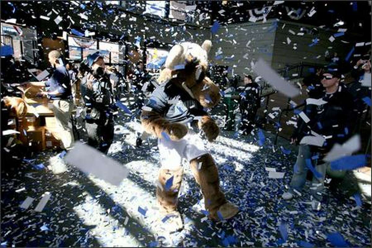 Mariners fans and the team mascot, the Mariner Moose, are showered with confetti as they enter Safeco Field to see the home team beat the Oakland A's 4-0 on opening day of the 2007 baseball season.