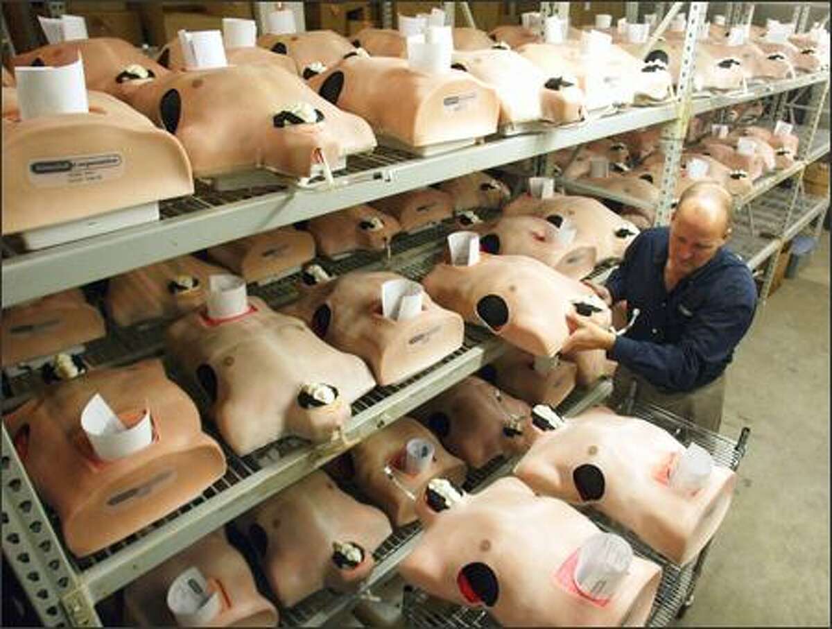 Chris Toly, president and CEO of Simulab Corp., inspects TraumaMan units before they're shipped to hospitals, universities and other medical facilities worldwide. The reusable artificial torsos, which cost $23,500 apiece, are used in medical training sessions.