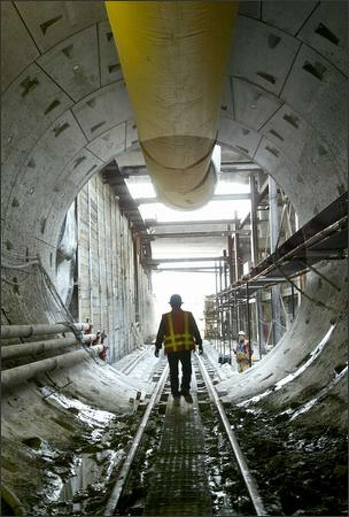 A worker leaves Sound Transit's Beacon Hill light rail tunnel during a media tour Wednesday. A 642-ton tunnel-boring machine, nicknamed the Emerald Mole, is digging the tunnel.