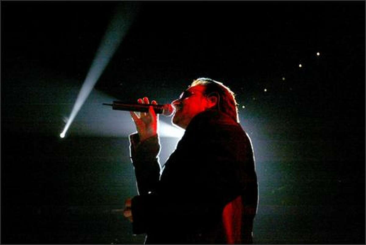 Bono sings "Love & Peace" at KeyArena.