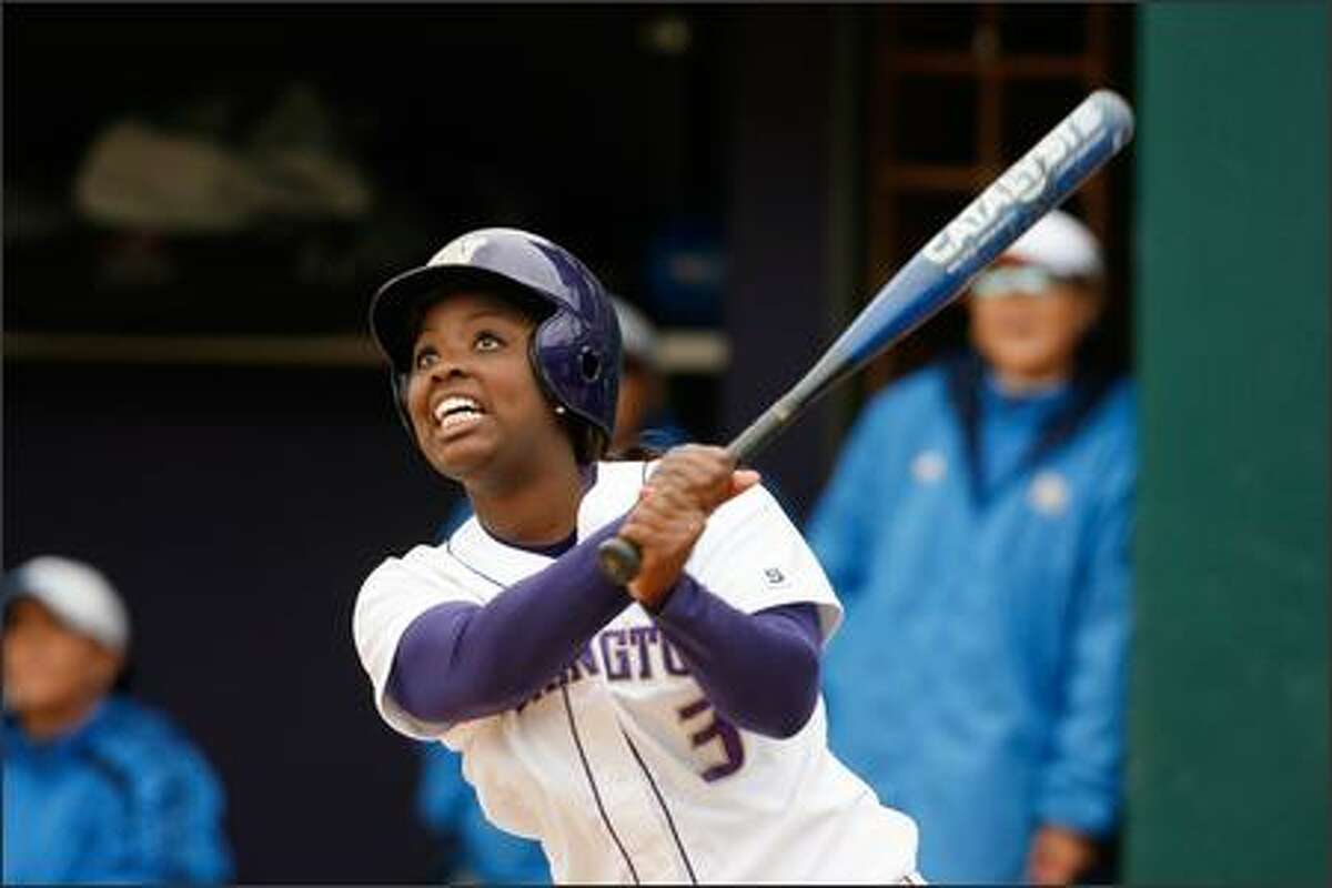 University of Washington's Dena Tyson watches her ball head for the left field fence ... only to go foul at the last moment. The Huskies beat UCLA 8-3 Wednesday, the 100th victory at the UW for head coach Heather Tarr.