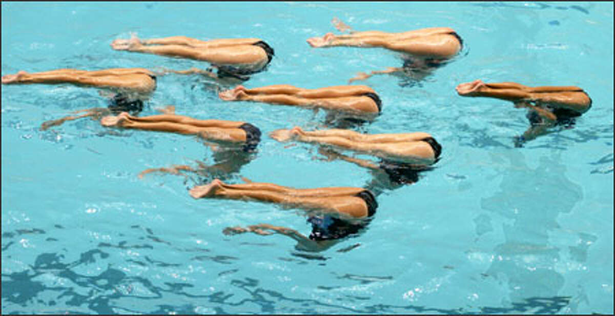One of these swimmers is not like the others: The Santa Clara Aquamaids, who have a guy on their team, practice a front pike at the 2005 Aflac U.S. National Synchronized Swimming Championship in Federal Way. Click to see where he is.
