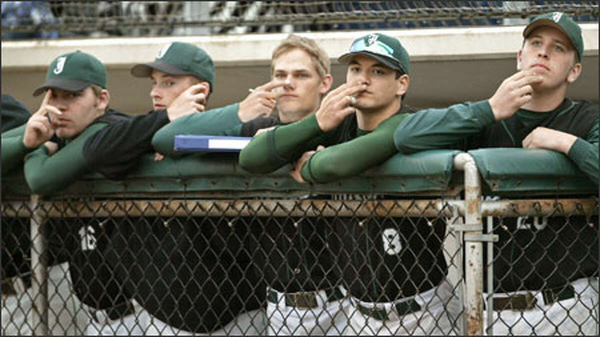 Jackson High School baseball players work in concert to conceal their team's signs to the catcher during an 8-2 victory over Everett High at Memorial Stadium in Everett. Jackson, with a 17-0 record, is ranked No. 3 in the nation. Shown here, from left, are Matt Ojala, Marc Schuermeyer, Riley Lillibridge, Kawika Emsley-Pai and Mike Jeffery.