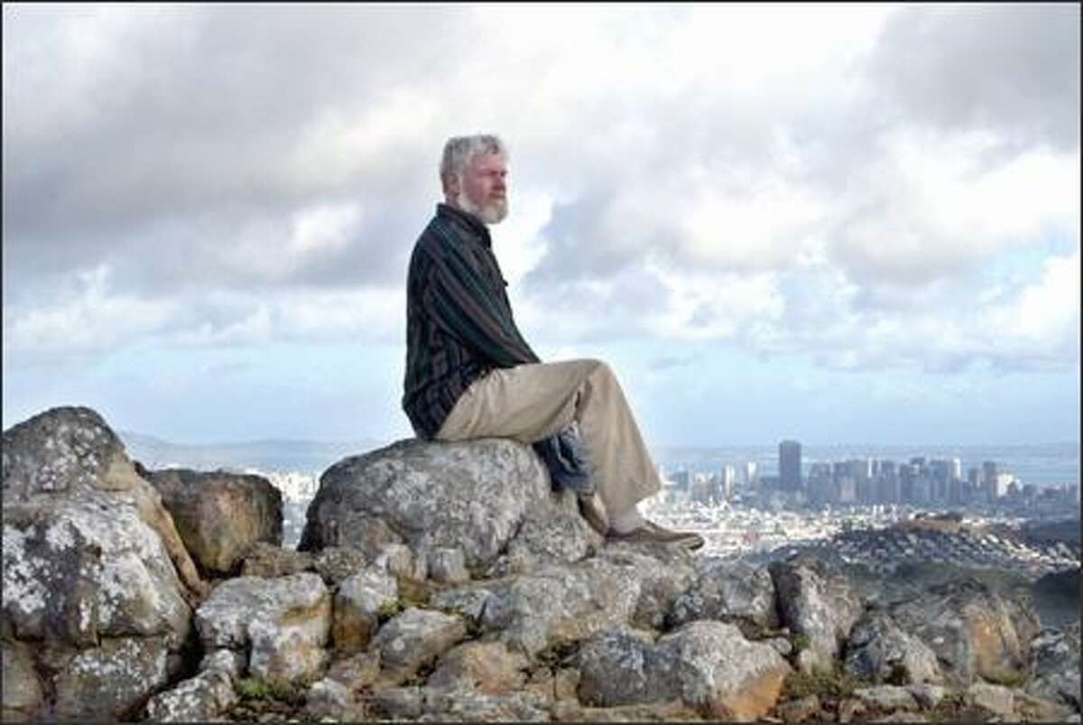 Environmentalist David Schooley, with San Francisco in the background, has led efforts to fix problems with the habitat protection plan at San Bruno Mountain, home to three rare butterfly species.