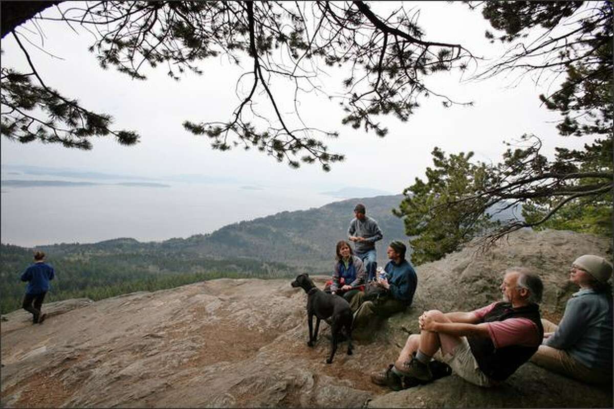 Hikers take in the views from the top of Oyster Dome on Blanchard Mountain.