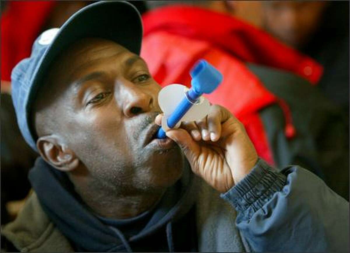 Eddie Samuels blows a party horn during a service Thursday at the Union Gospel Mission honoring the birthdays of Seattle homeless people. It was the second year that the mission has honored the birthdays of the homeless, regardless of their actual birth dates.