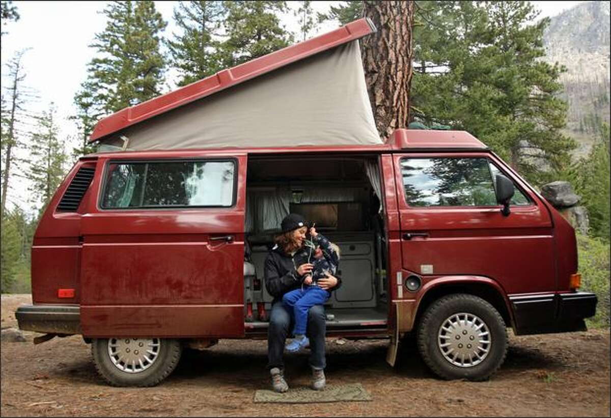 French Au Pair Camille Gaillard sits with Solomon Barnett, 2, in a friend's VW Westfalia at a campsite in Wenatchee National Forest along Icicle Creek, near Leavenworth, Wash.