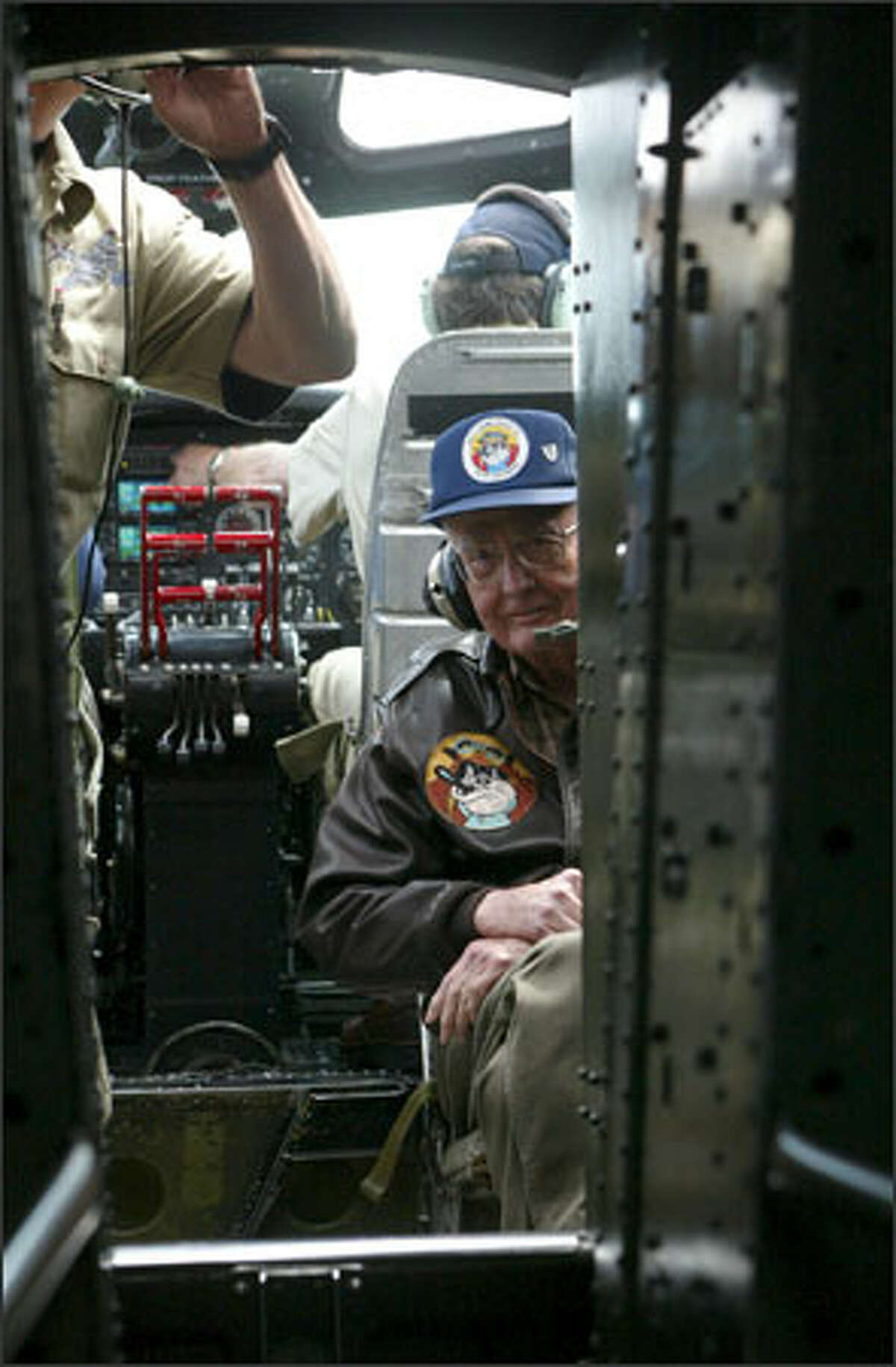 Russ Reed, 82, a B-17 pilot in the war, sits behind bomber pilots during a flight Wednesday. Reed, who flew with the 398th Bomb Group in the 603rd Squadron, was shot down in 1944 on his fifth mission over Germany and spent four months as a prisoner of war. Another guest for the nostalgic flight Wednesday was 90-year-old Ike Alhadeff. He also is a former B-17 pilot who was shot down in 1944 over Germany. Between 1935 and 1945, 12,731 B-17s rolled out of Boeing, Douglas and Lockheed plants across the country, including in Seattle. The Aluminum Overcast, which is painted in the colors of the 389th Bomb Group, was built in 1945 but was delivered to the Army Air Corps too late to see service in the war.