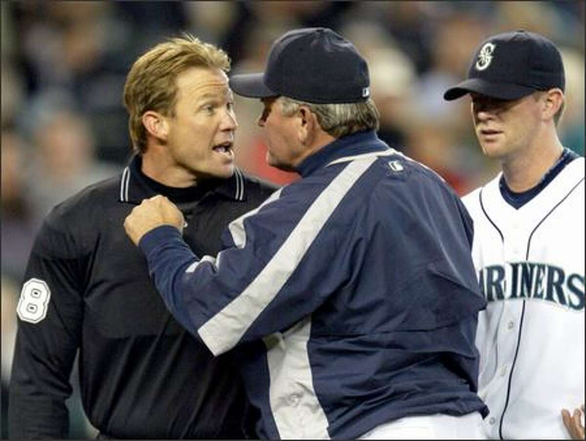 Manager Mike Hargrove gives home plate umpire Jim Wolf an earful as pitcher Ryan Franklin looks on after Wolf tossed Franklin out of Tuesday's game in the third inning for hitting Toronto's Reed Johnson with a pitch. Seattle trailed 7-0 at the time and ended up losing 9-7.