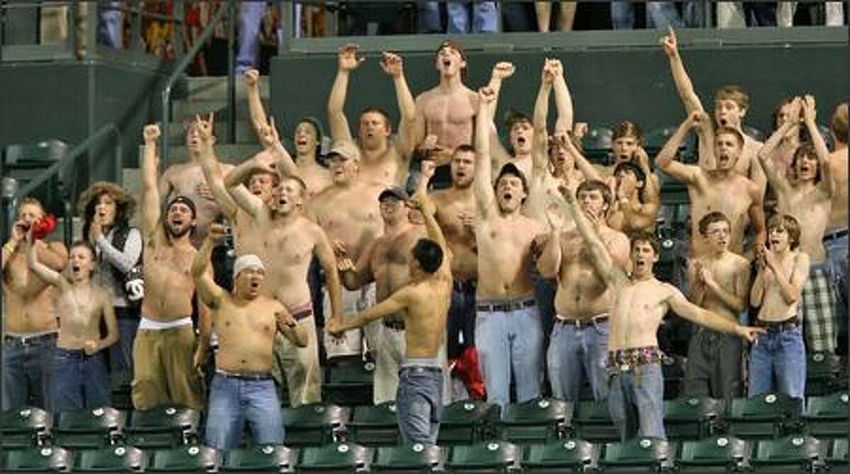 Half-naked Mariners fans cheer the final out in the home team's 5-4 win over the Baltimore Orioles.