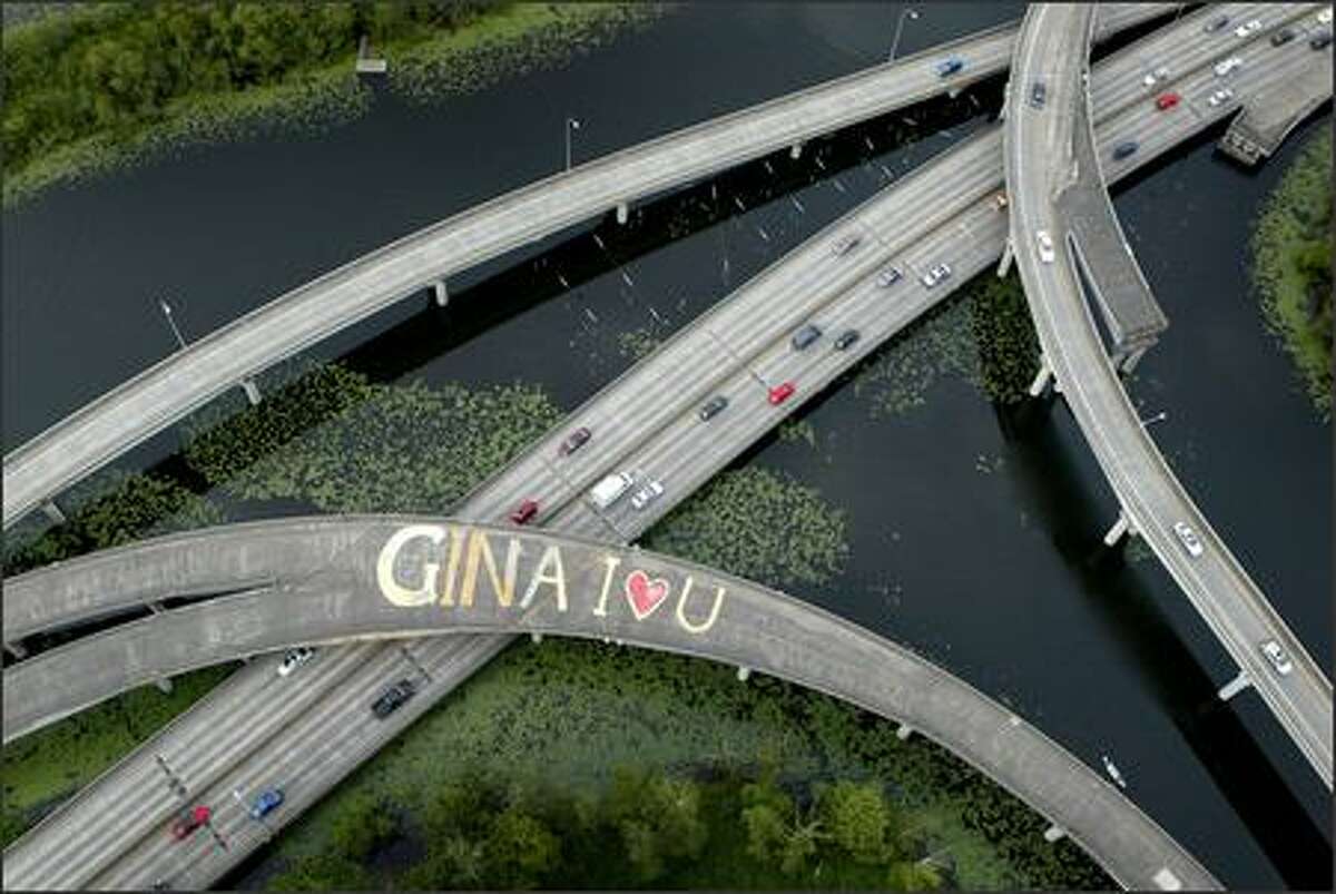 A message of love to an unknown "Gina" is scrawled across the lanes of an overpass on Highway 520 in the Arboretum on Tuesday in Seattle. The message was painted on an unused ramp on the highway in the serene park. The painter and the recipient of the message are mysteries.