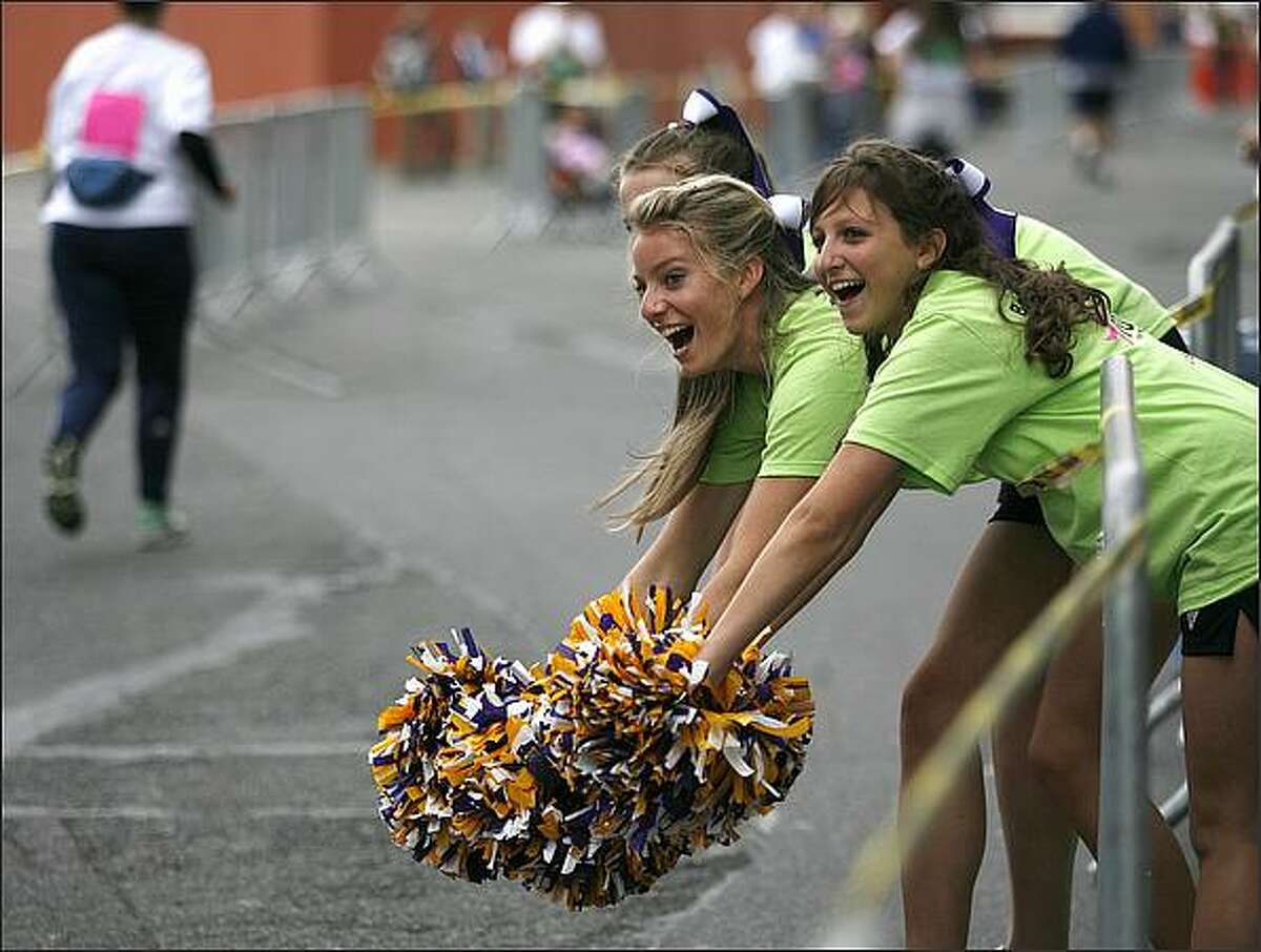 Issaquah High School cheerleaders root for runners at Puget Sound Susan G. Komen Race for the Cure outside of Qwest Field on Saturday. The race helps to raise money for breast cancer research, education and treatment. (Seattle Post-Intelligencer/Kristine Paulsen)